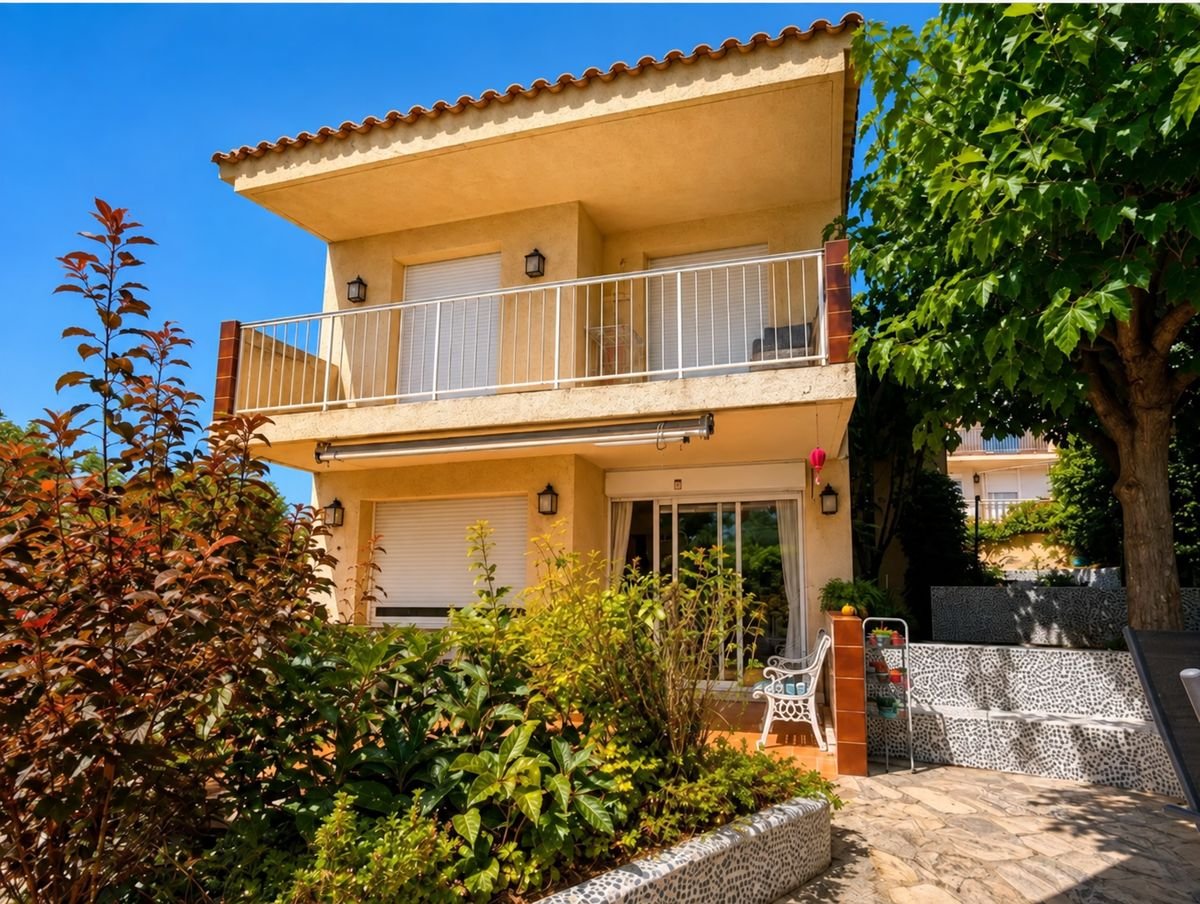 Front of the house, with garden and first-floor balcony